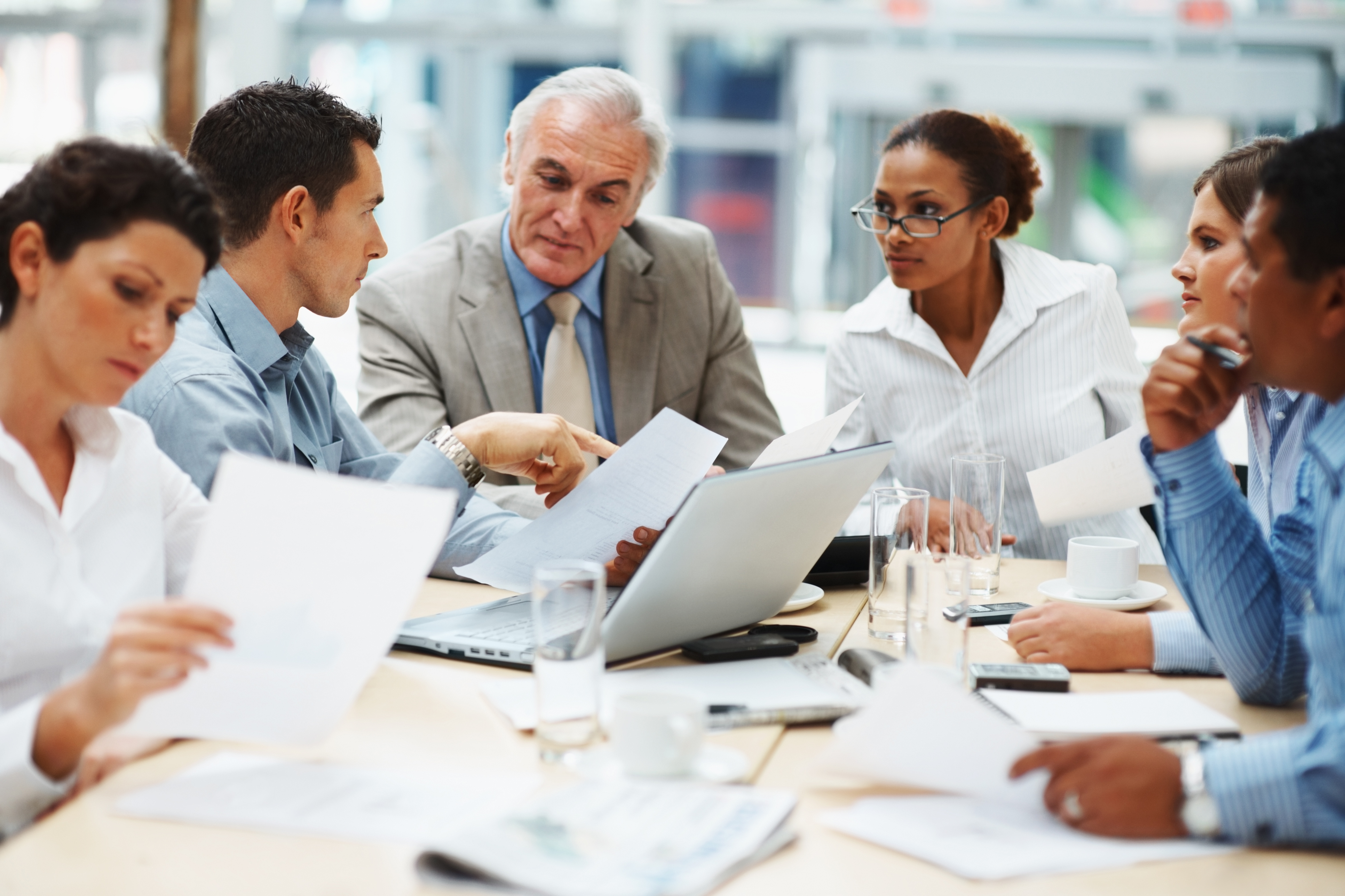 Decorative;  Adults Confering Over Document